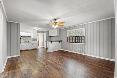 Unfurnished living room with dark wood finished fl