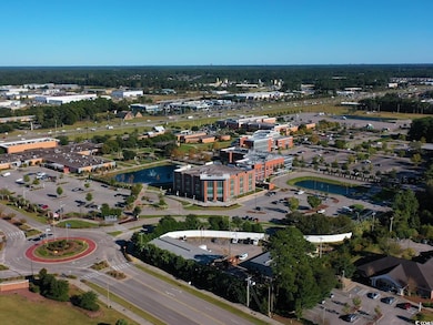 Aerial view of property and surrounding area featuring a nearby body of water