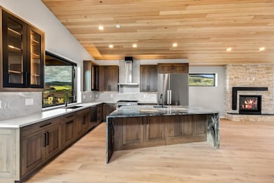 Kitchen with range with gas cooktop, wall chimney