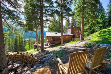 View of yard with a wooden deck and a forest view