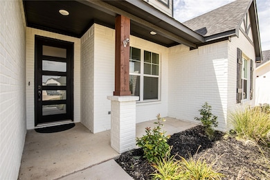 Entrance to property featuring covered porch