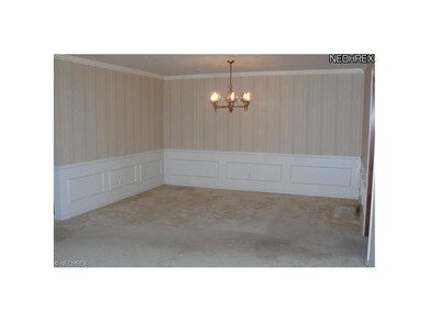 Dining room has wainscoting and crown molding.  Ve