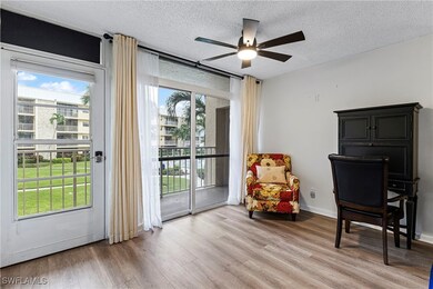 Sitting room with a textured ceiling, healthy amount of natural light, light wood finished floors, and a ceiling fan