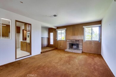 step-down living room with gas brick fireplace