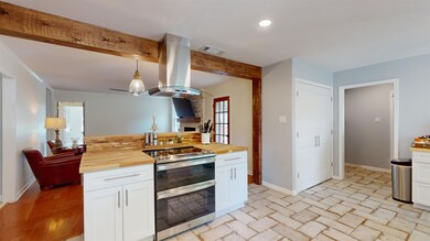 Kitchen with stainless steel range with electric c