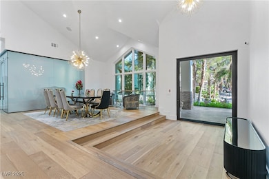 Dining space featuring high vaulted ceiling, light
