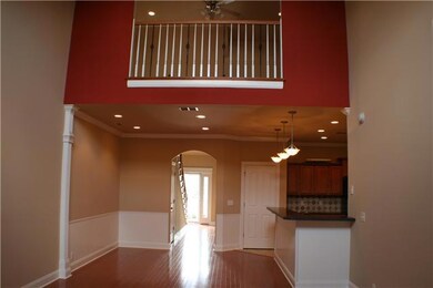 Great room has a beautiful accent wall with archway in loft area and two dormer windows for plenty of natural light.