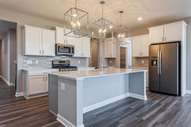 Stunning kitchen with waterfall island. Open concept throughout. Space for all your friends and family to gather together!