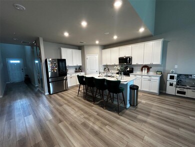 Kitchen featuring stainless steel appliances, lig