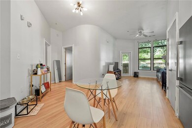 Dining area with light wood finished floors and ceiling fan