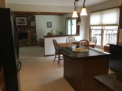 Kitchen features an island with pendant lighting a