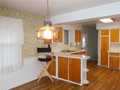 L-shaped counter allows more space for cabinets and entertainment/prep area.