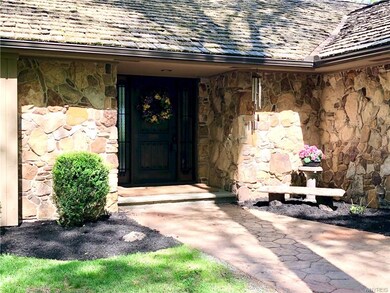 Stone and cedar siding with a cedar shingle roof, 