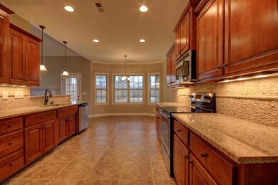 Extra Wide Galley Kitchen with Upgraded Cabinetry and Beautiful Stone Backsplash 