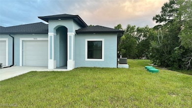 View of front of house with a yard, central AC uni