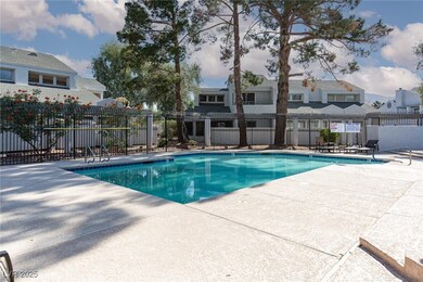 Community pool with a patio area and a residential