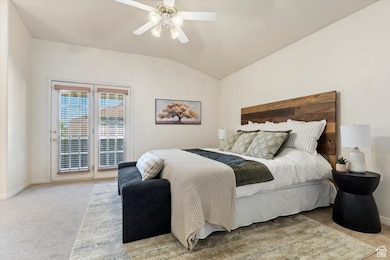 Bedroom featuring access to balcony, vaulted ceiling, and an ensuite bathroom