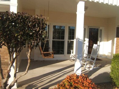 Relax on room size front porch. Home faces South. Rocking Chairs and Swing included.