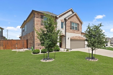 Traditional home with driveway, brick siding, a g