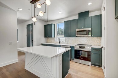 Kitchen featuring stainless steel appliances, tas
