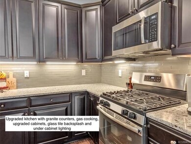 Kitchen with granite counters, glass tile backspla