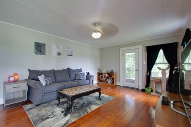 The living room is spacious and leads to the dining room and to the screened in patio.