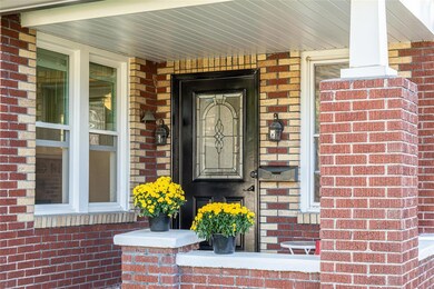Warm brick home with large front porch invites you
