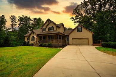 Craftsman-style house featuring a garage, covered 