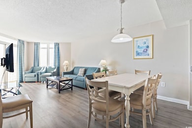 Dining room featuring a textured ceiling and wood finished floors