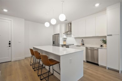Kitchen featuring stainless steel appliances, wal