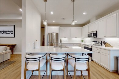 Kitchen featuring white cabinets, sink, and stainl