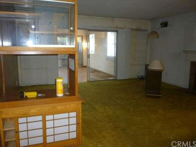 Living room with built in display case and den in 