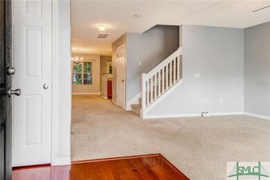 Wood floored foyer area with coat closet