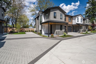 Parking pad to the left of this Townhome is assigned to Unit A as well as one car garage.