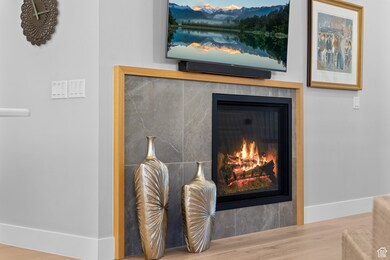 Detailed view of wood finished floors and a tile fireplace