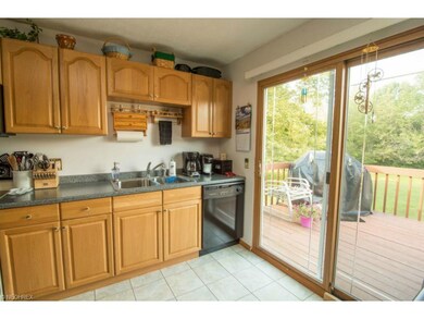 Large kitchen with newer cabinets and sliding door