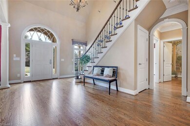 Two story foyer. Custom moldings, architectural detail throughout.