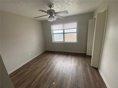 Unfurnished bedroom with dark wood-type flooring,