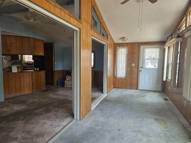 Unfurnished sunroom featuring vaulted ceiling