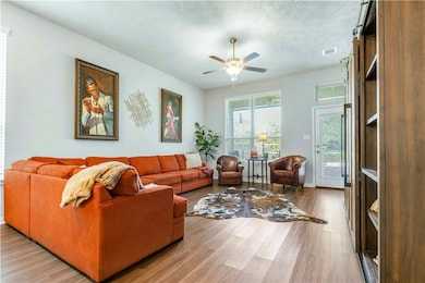 Living room with visible vents, baseboards, a ceil