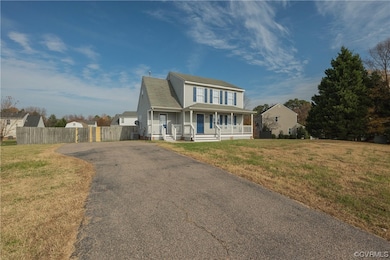 View of front of property with a front yard and and driveway