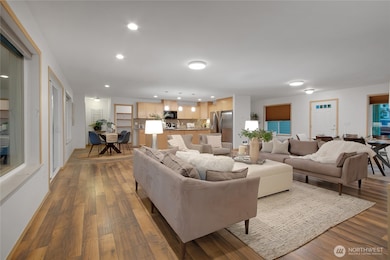 open concept common area staged with dining and living area