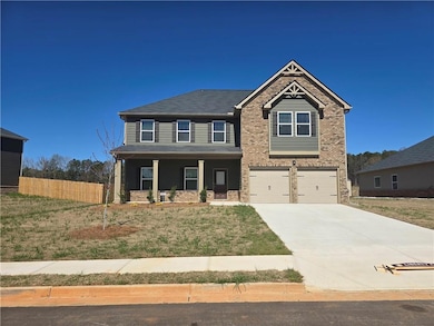 Craftsman house with an attached garage, covered p
