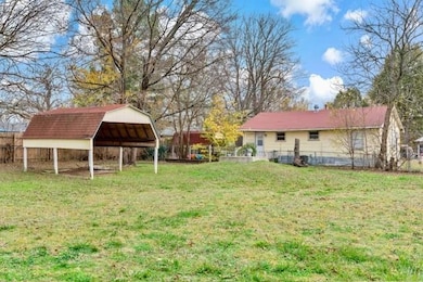 View of yard with a carport