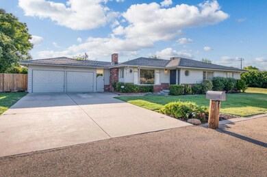 Wide deep driveway with lawn on both sides