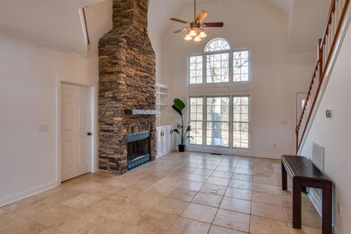 Great room with tile floors and stone fireplace