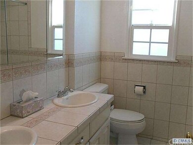 Bathroom with dual sinks, shower over tub