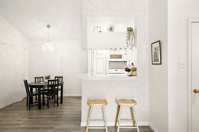 Dining space featuring dark wood-style flooring a
