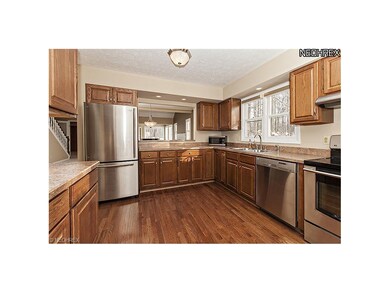 Updated Kitchen features gleaming wood floors,stai