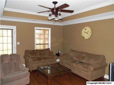 Living Room features Hardwood flooring and vaulted ceiling, crown molding, ceiling fan and can lightning.
